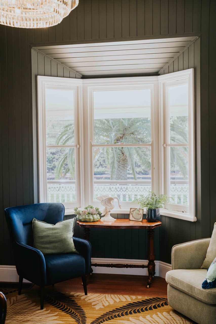 A reading nook framed by the home's original bay window.