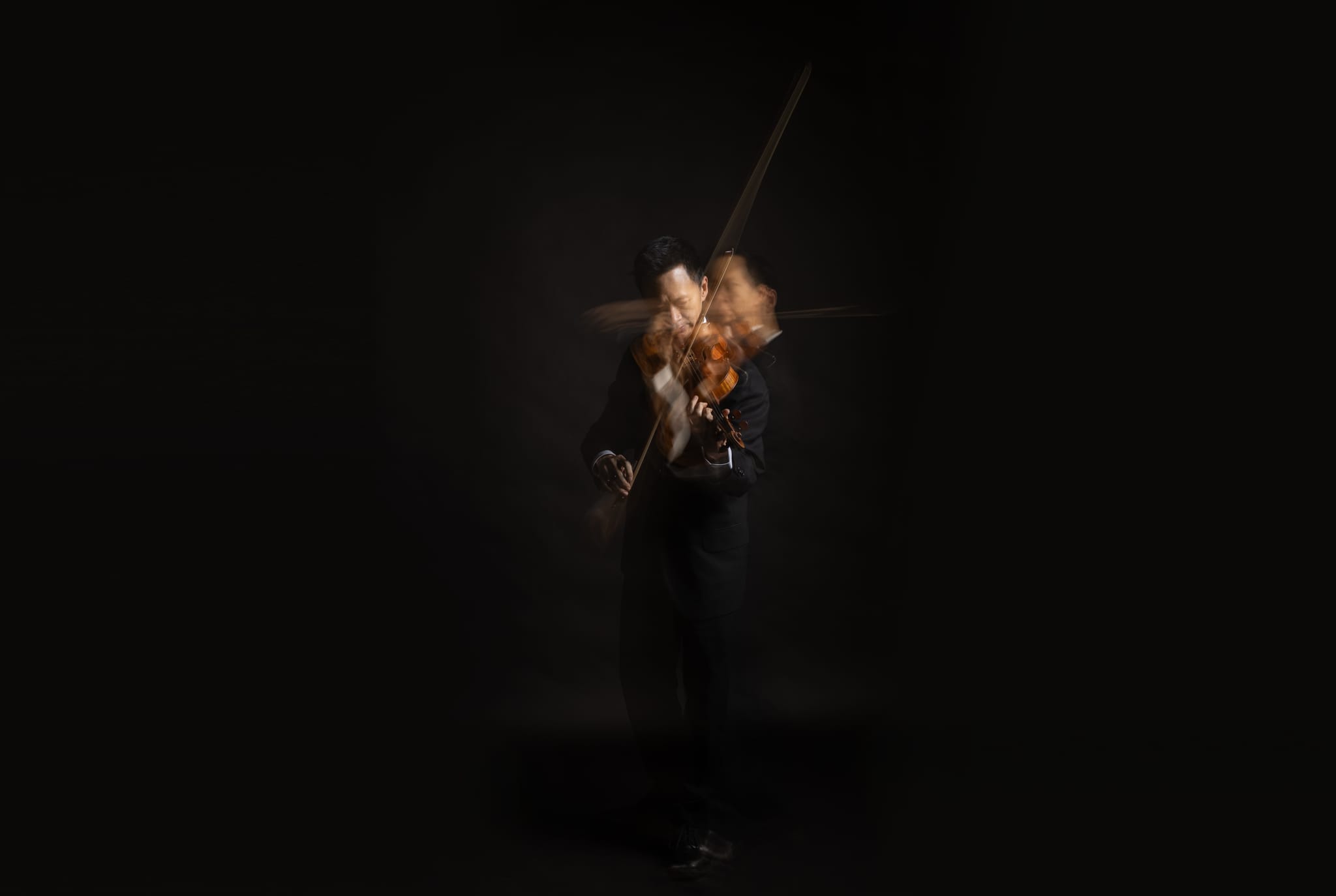 A QSO violinist, from the orchestra's 80th anniversary season campaign photography.