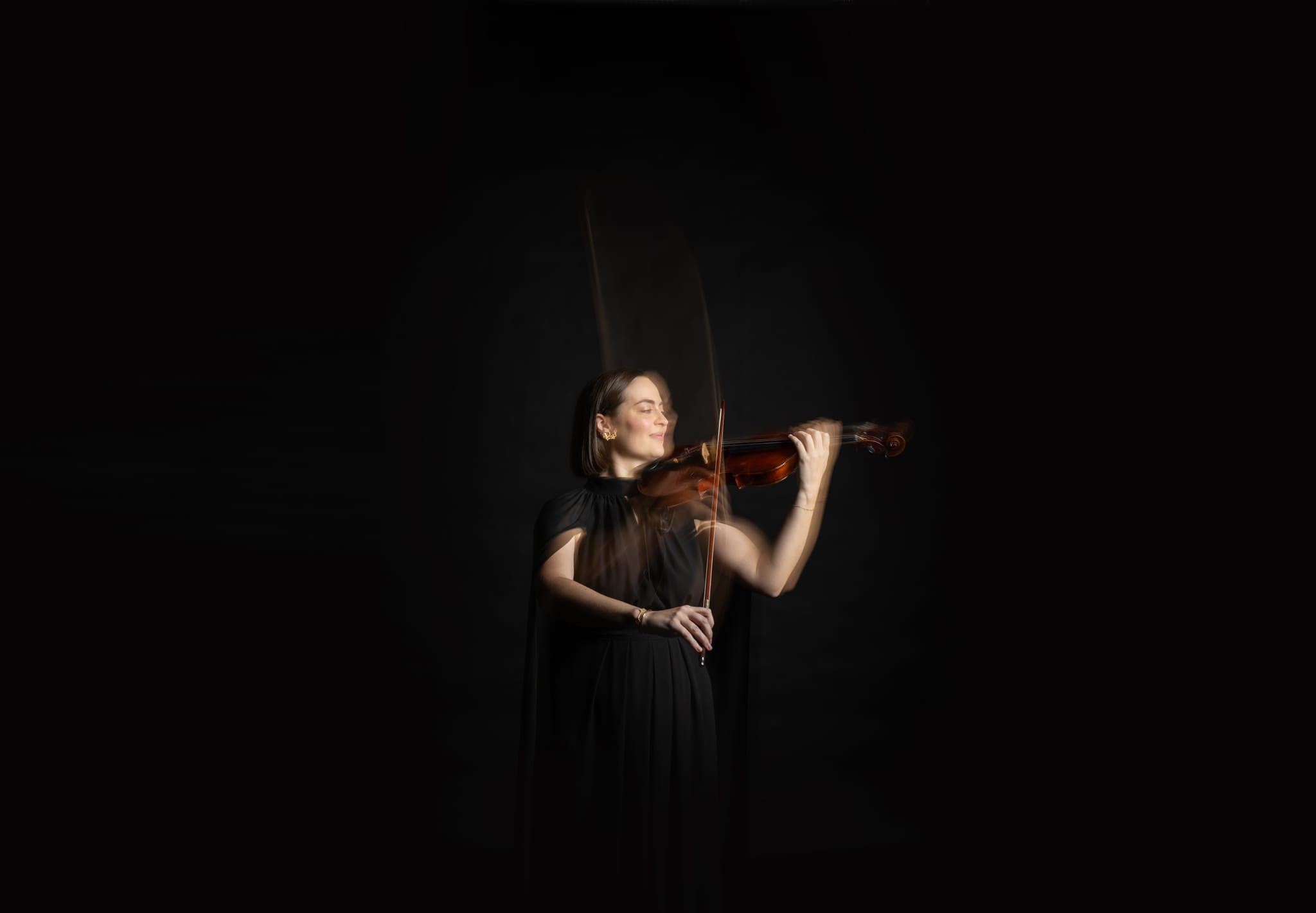 A QSO violinist, from the orchestra's 80th anniversary season campaign photography.