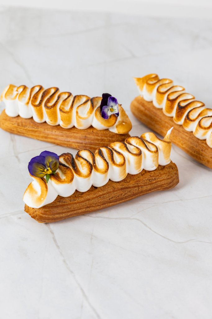 Lemon meringue éclairs with pansies at Eclair at the Bay